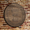 Wooden plaque with 'Street Legal Art' text on a brick wall background