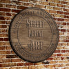 Wooden plaque with 'Street Legal Art' text on a brick wall background